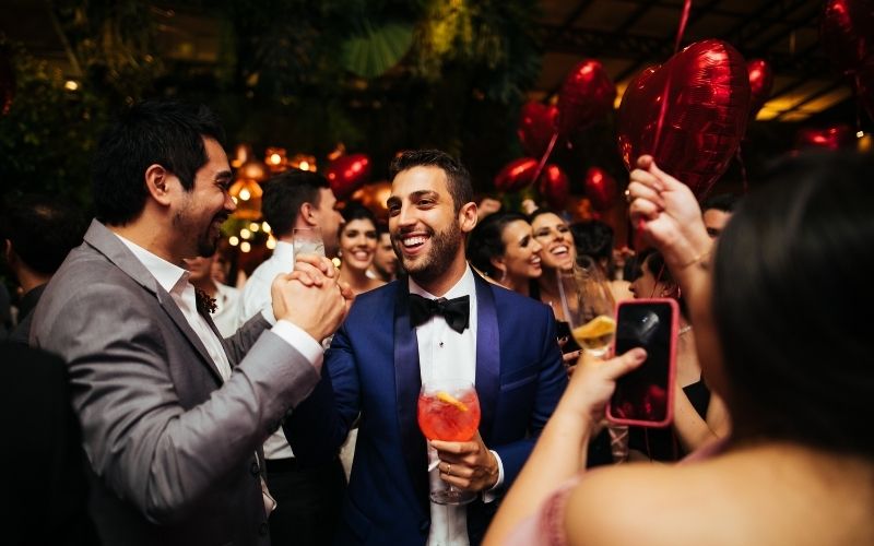 Groom celebrating his wedding with cocktails