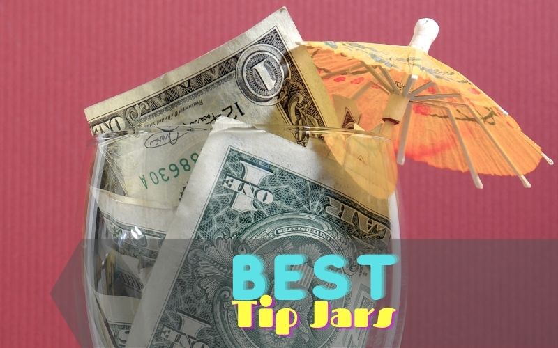 Dollar bills in a cocktail glass with an umbrella