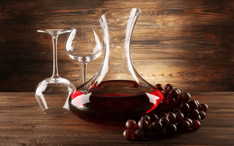 A carafe beside two wine glasses