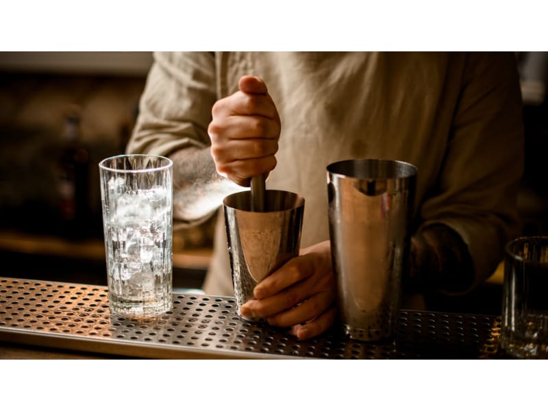  A bartender using a muddler