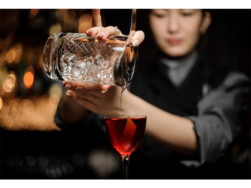 Bartender using a cocktail strainer