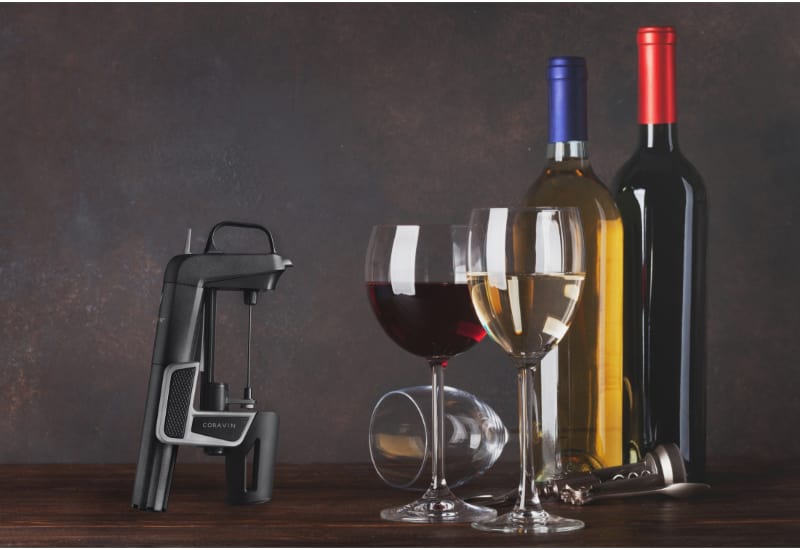 Coravin, 2 wine glasses and 2 bottle of wine on the table