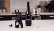 Coravin wine preservation system with wine bottle and wine glass on the table