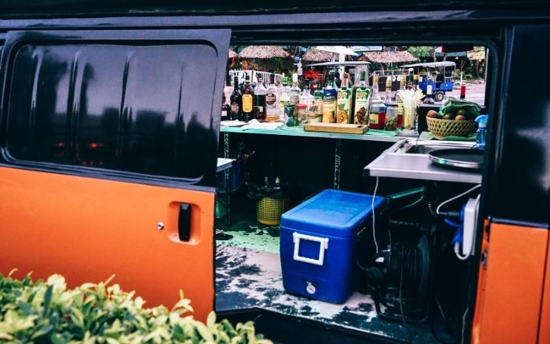 People hanging outside the mobile bar