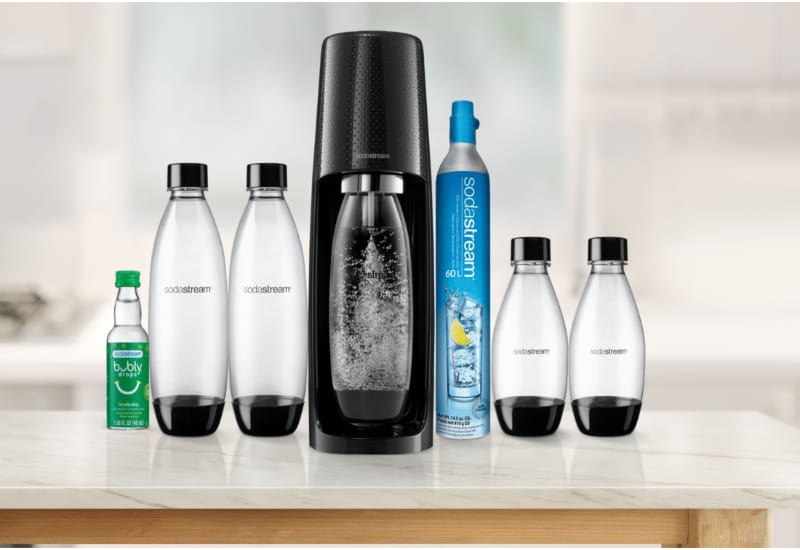 SodaStream machine with carbonating bottle on a kitchen counter