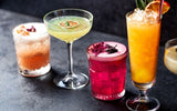 Tasty colored cocktails with various garnishes